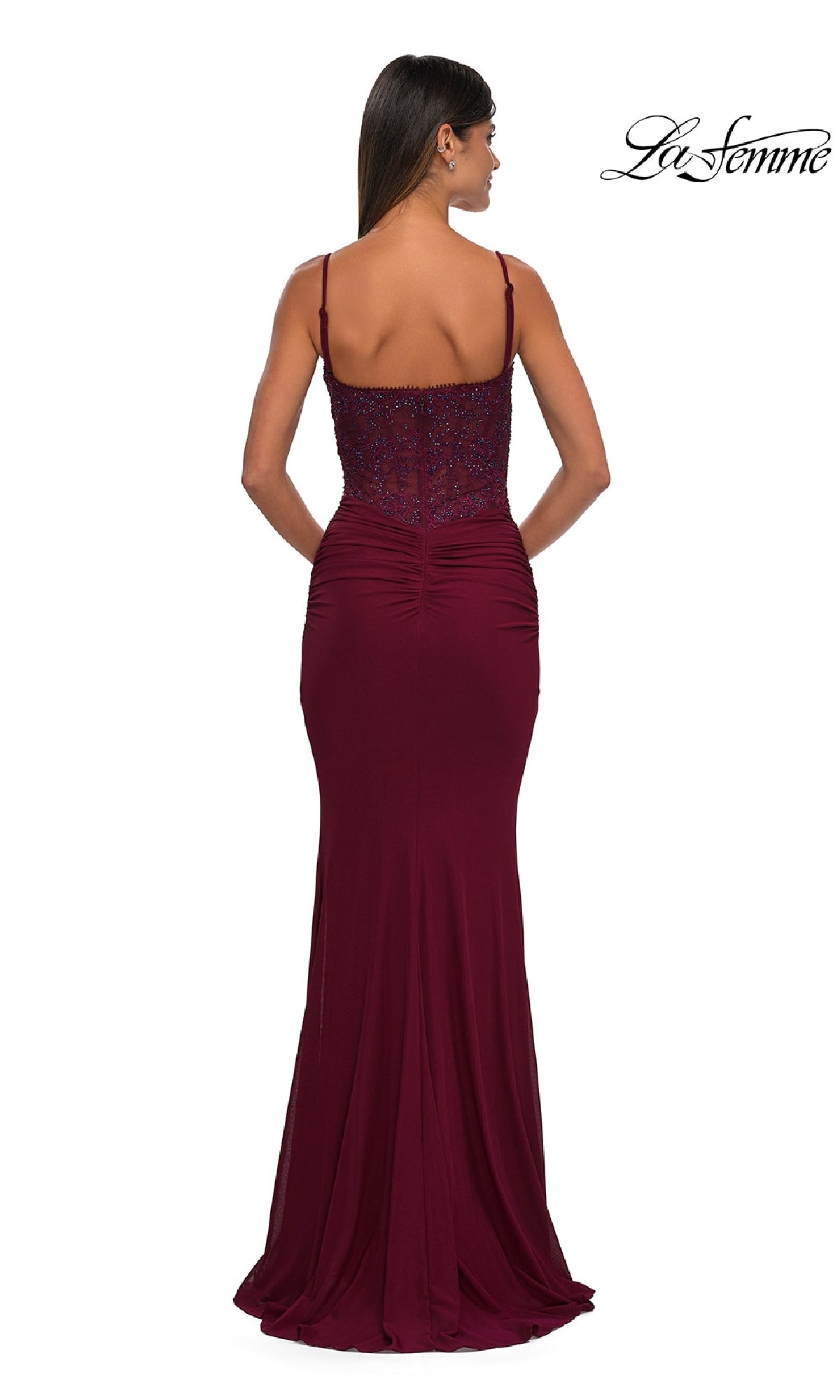 A woman is pictured from the back wearing the La Femme 32357, a sleeveless, floor-length burgundy prom dress with thin straps and a fitted ruched bodice. The La Femme logo is visible in the top right corner.